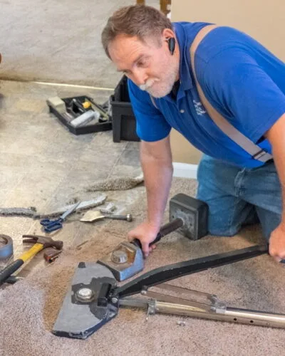 Stretching carpet with power stretcher repairs